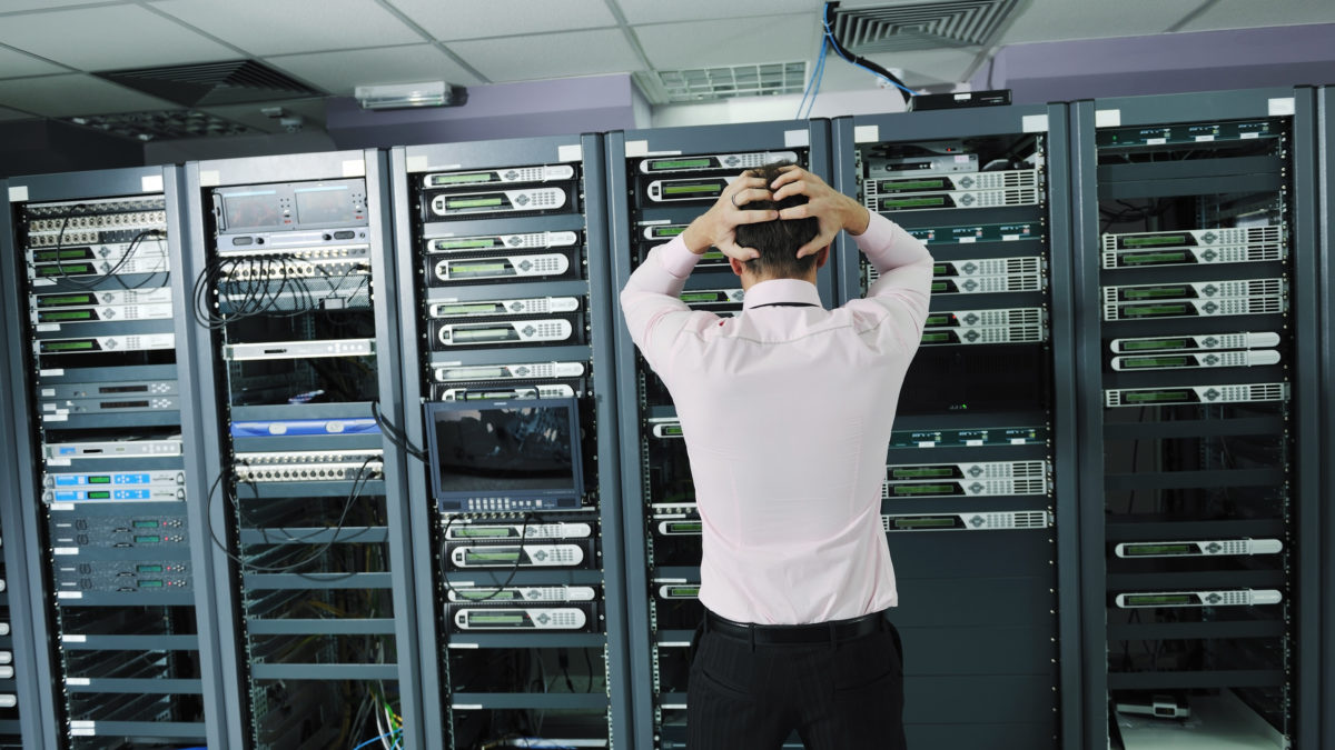 it business man in network server room have problems and looking for  disaster situation  solution