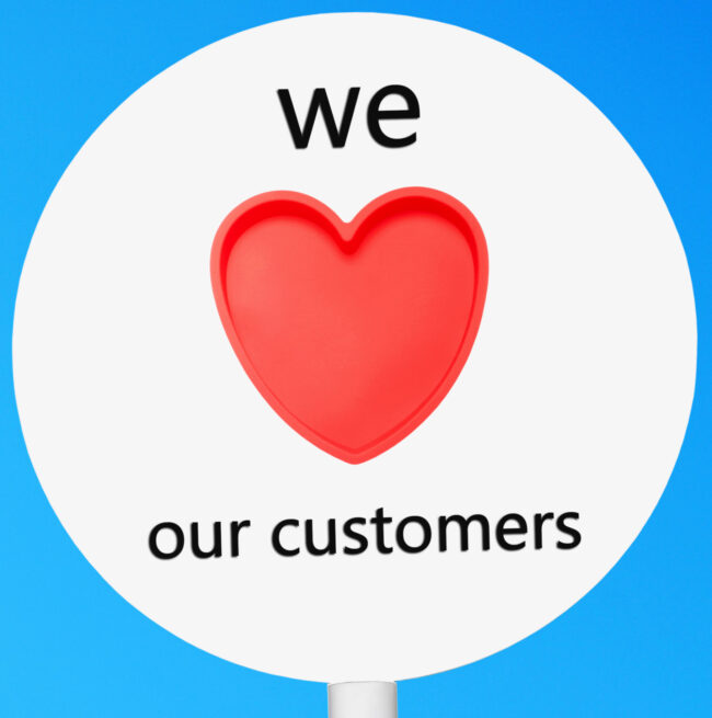 conceptual picture regarding business customer care saying we love our customers (against a blue sky background)